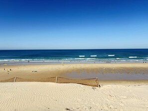 A beach with a sandy area and a netted section, likely for beach volleyball or similar activities. - Sunny villa with terrace near the beach (Biscarrosse Plage)