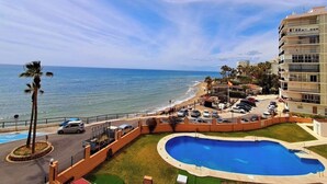 A resort with a pool, beach access, and a view of the ocean. - Beachfront studio (Calahonda)