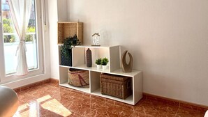 A room with a white shelving unit against a wall, containing woven baskets, a vase, and a small plant. - Island Circobueno - 5609 (Arnuero)