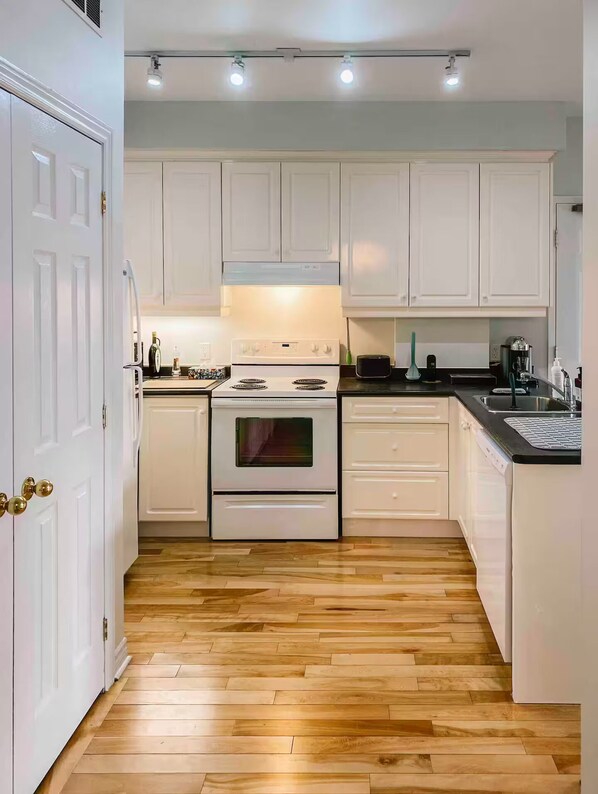 Kitchen features a double oven, sink, and various appliances.