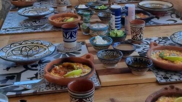 A dining table set with traditional Moroccan dishes, plates, and cups. - Anza Sets House  (Anza)