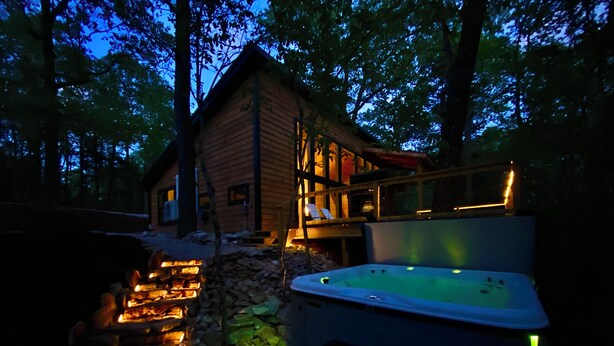 A wooden cabin with a hot tub and a stone fire pit. - Cedar Hill Cabin 2 bed 2 bath cabin in the Ozarks • Hot Tub • (Harrison)