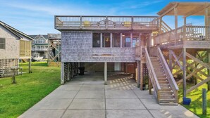 A two-story wooden structure with a balcony and a covered area, connected by a staircase. - Relaxing family and dog friendly getaway located in Hatteras (Hatteras)