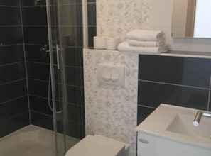 A modern bathroom with a glass-enclosed shower, a white sink, and a toilet. - Cozy Vodice Garden Apartments With Terrace and BBQ (Vodice)