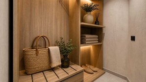 A wooden vanity with a shelf holding a woven basket, a towel, and a vase with a plant. - Exclusive Retreat off the Seafront Promenade (Il-Gżira)