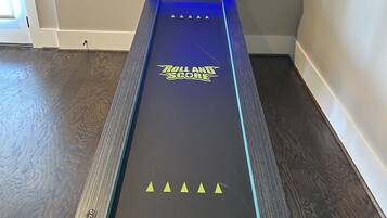 A game table with 'Roll and Score' branding, a score display, and a 'Hall of Games' logo.