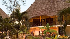 A resort with thatched-roof buildings, palm trees, and a well-maintained garden. - Kisiwa Apartments Watamu at Ascot Resort  (Watamu)