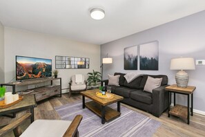 Condo, Multiple Beds, Patio, Garden View (220 Peterson St. (Unit 3,4,7,8)) | Living area | 50-inch flat-screen TV with digital channels - Peterson Flats Urban Group Getaway (Fort Collins)