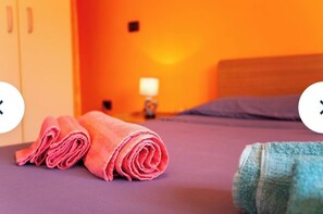 Relax in this inviting room with a comfortable bed, bathtub, and convenient storage space.