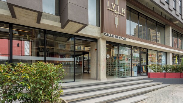 A modern building with a prominent sign reading "IVIN 567 N7-36" and "Calle 56 N7-36". - Ivin 567 by Atelier (Bogotá)