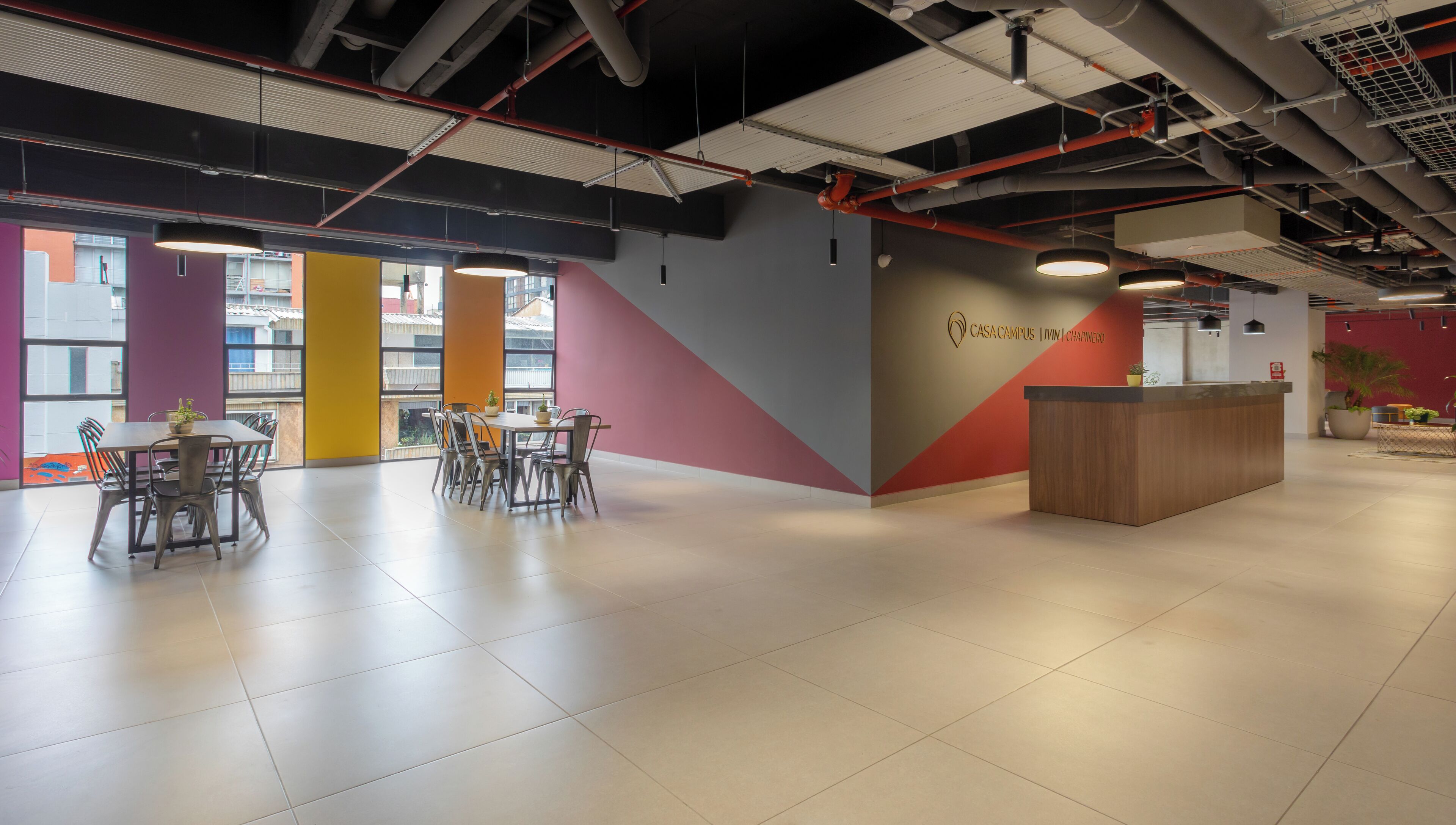 A spacious, modern reception area with a reception desk, seating area, and large windows providing natural light.