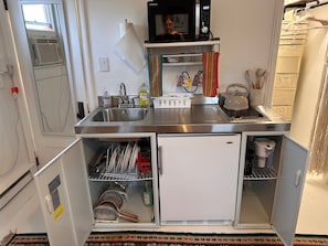 Enjoy cooking in this well-organized kitchen with a stainless steel sink, dishwasher, microwave, and kettle.