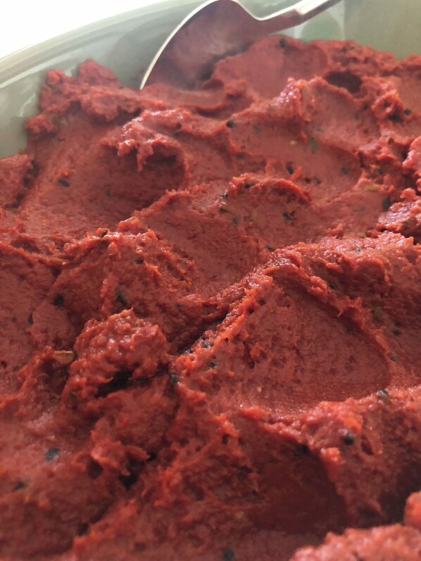 A close-up of a red, textured food item in a bowl. - Assos Pırnal Köy Evi (Ayvacik)