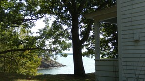 A house with a porch overlooking a lake. - Spacious Grindstone Island House across from Clayton, NY (Clayton)