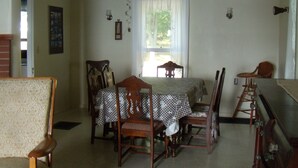 A dining room with a table set for four, surrounded by wooden chairs. - Spacious Grindstone Island House across from Clayton, NY (Clayton)
