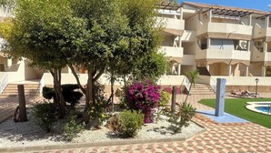 A courtyard with a pool, surrounded by a multi-story building with balconies. - Lovely Holiday Place with pool, A/C, TV, WIFI - Playa Sol Vinaros (VC)