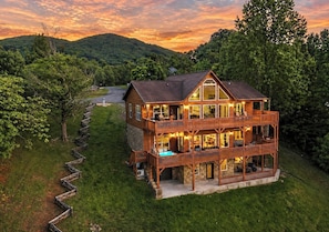 A two-story wooden house with a balcony, a swimming pool, and a view of the surrounding forest. - Sleeps 16 - Game Room - Hot Tub - Fire Pit - Private Acre (Cosby)