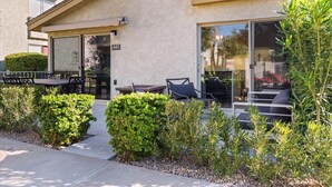 A building with a beige exterior, a number '441' on the door, and outdoor seating with cushions. - BE FIRST TO STAY at The Camelback Retreat in Scottsdale (Scottsdale)