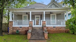 A two-story house with a front porch, a brick foundation, and a number 783 on the door.
