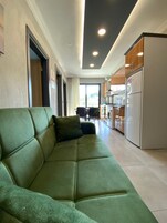 Deluxe Apartment, Balcony, Pool View | Living area | TV