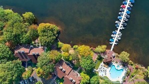 An aerial view of a lakeside property with multiple buildings, a swimming pool, and a dock with boats. - Big Boulder Relaxation, Slopes Up, Big Boulder, Jack Frost Ski Resorts  (Lake Harmony)