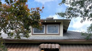 A two-story house with a brown door, a small porch with a light fixture, and a number '103' sign on the front. - Charming 2-bedroom house in busy downtown Indianapolis with WiFi, AC. (Indianapolis)