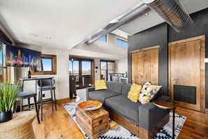 Townhome, Multiple Beds, Hot Tub, Mountain View (200 S College Ave) | Living area | 64-inch flat-screen TV with digital channels, fireplace - Penthouse With Mountain Views in Heart of Old Town (Fort Collins)