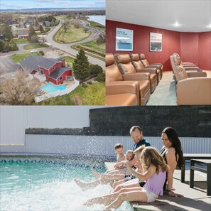 A residential area with a swimming pool, a red building, and a row of leather recliners.