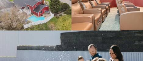 A residential area with a swimming pool, a red building, and a row of leather recliners.