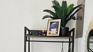 A bunk bed with a framed WiFi sign, a potted plant, and a mirror on the wall. - Close to several beaches but away from all the hustle and bustle.  (Quebrada Ganado)
