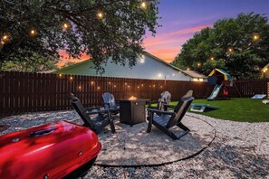 A backyard with a barbecue area, outdoor seating, and a children's play structure. - 🌟 Perfect Stay for BMT Graduation • 5 Min to Lackland AFB & SeaWorld (San Antonio)