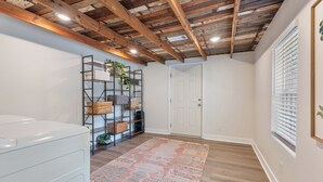A laundry room with a wooden ceiling, a white door, and a window with blinds. - Modern Charming 3BR/2BA Home. Walking distance to Downtown Benton & Tyndall Park (Benton)