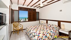 Une chambre avec un lit, une chaise, une télévision et une fenêtre donnant sur un beau paysage.
