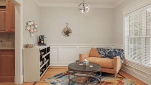 A cozy living room with a round coffee table, a beige sofa, and a patterned rug. - Cozy Colors Hideaway (Saint Joseph)