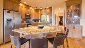 A modern kitchen with granite countertops, stainless steel appliances, and wooden cabinets. - Waterfront Home w/ Beach access! (Port Ludlow)