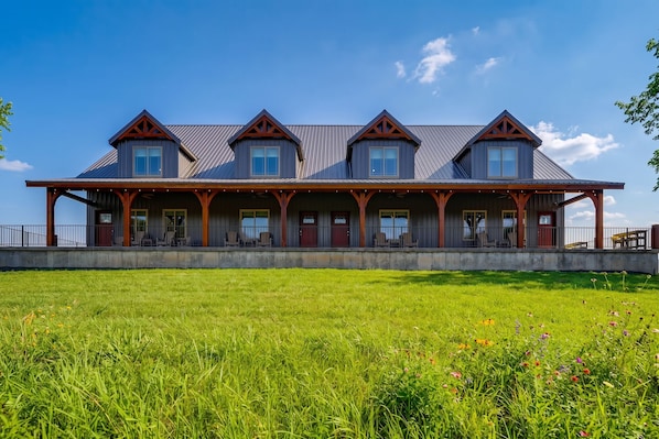 A large building with multiple windows and a covered porch.