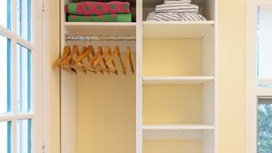 A walk-in closet with open shelves, a hanging rod, and a window. - Charming studio in delightful Provincetown with WiFi, AC (Provincetown)
