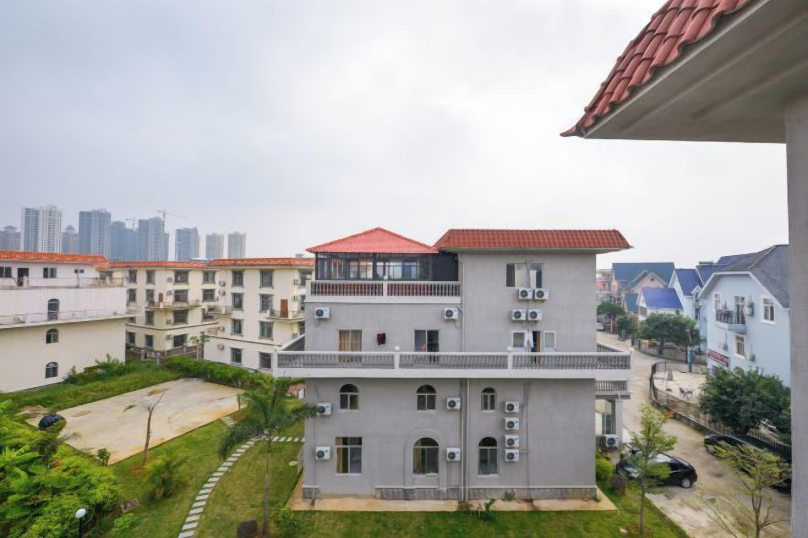 A multi-story residential building with balconies, air conditioning units, and a courtyard.
