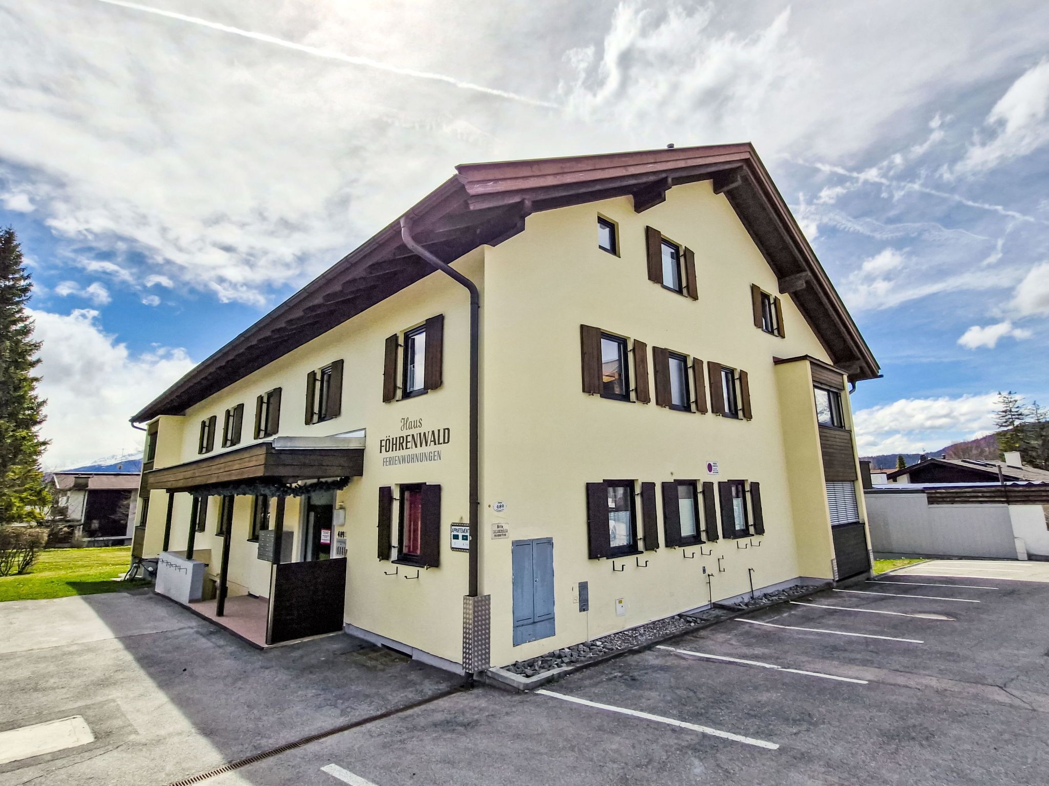 A two-story building with a sign reading "Haus FÖHRENWALD Ferienwohnungen."