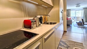 Een moderne keuken met een geïntegreerde kookplaat, een broodrooster en een spoelbak.