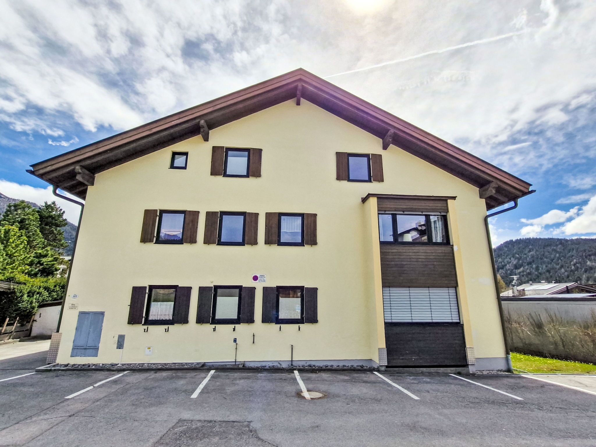 A two-story building with a flat roof and a central entrance.