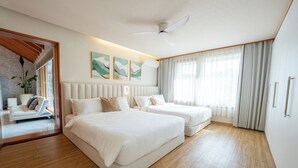 Habitación de hotel con dos camas, ventilador de techo, ventana grande con cortinas y vistas al exterior.