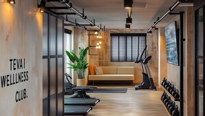 A gym with treadmills, dumbbells, and a stationary bike.