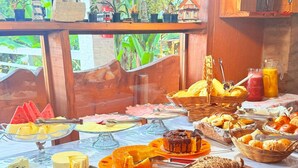 Ein Buffet mit verschiedenen Speisen und Blick auf eine grüne Umgebung.