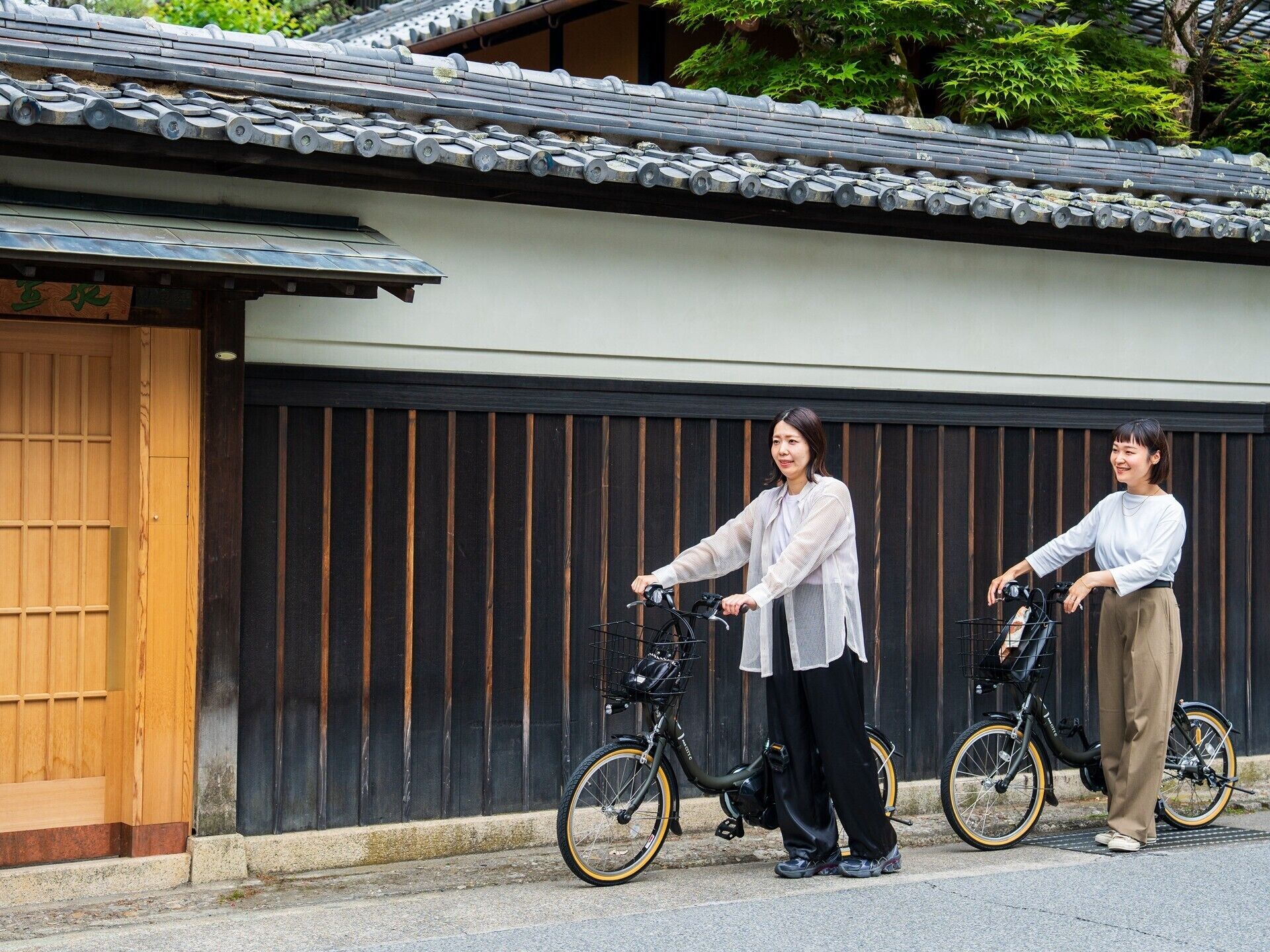 A traditional Japanese building with a tiled roof and a wooden door.