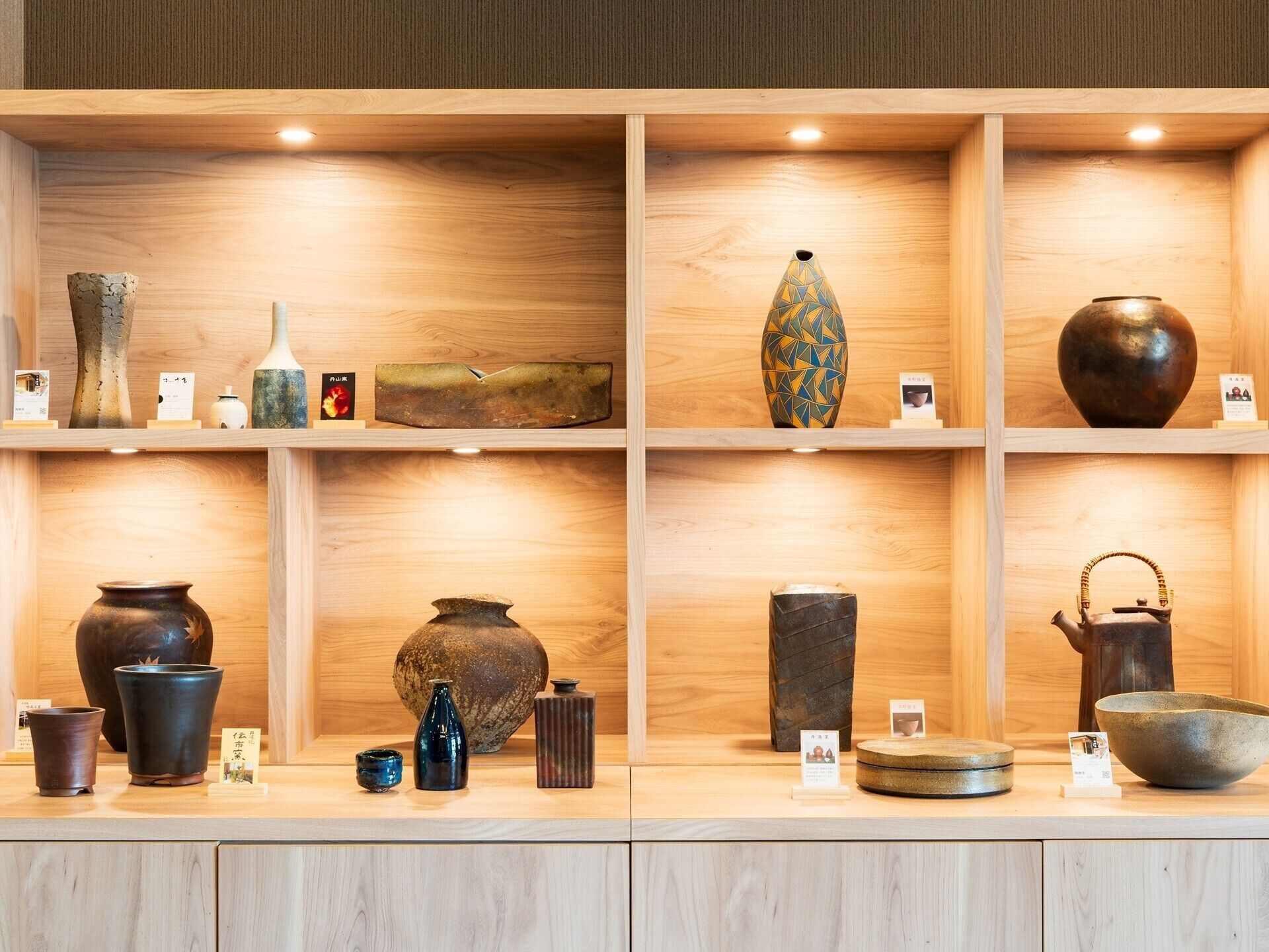 A display of various ceramic and pottery items on shelves.