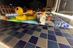 A pool area with inflatable toys and a tiled edge. - Honghai Bay Haihang Holiday Hotel (Huidong)