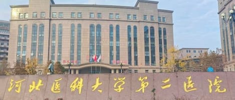 A large institutional building with a symmetrical facade, multiple windows, and a prominent entrance.