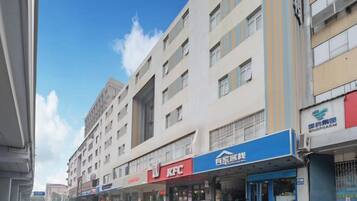 Un edificio de varios pisos con locales comerciales en la planta baja, incluyendo un KFC y un banco.