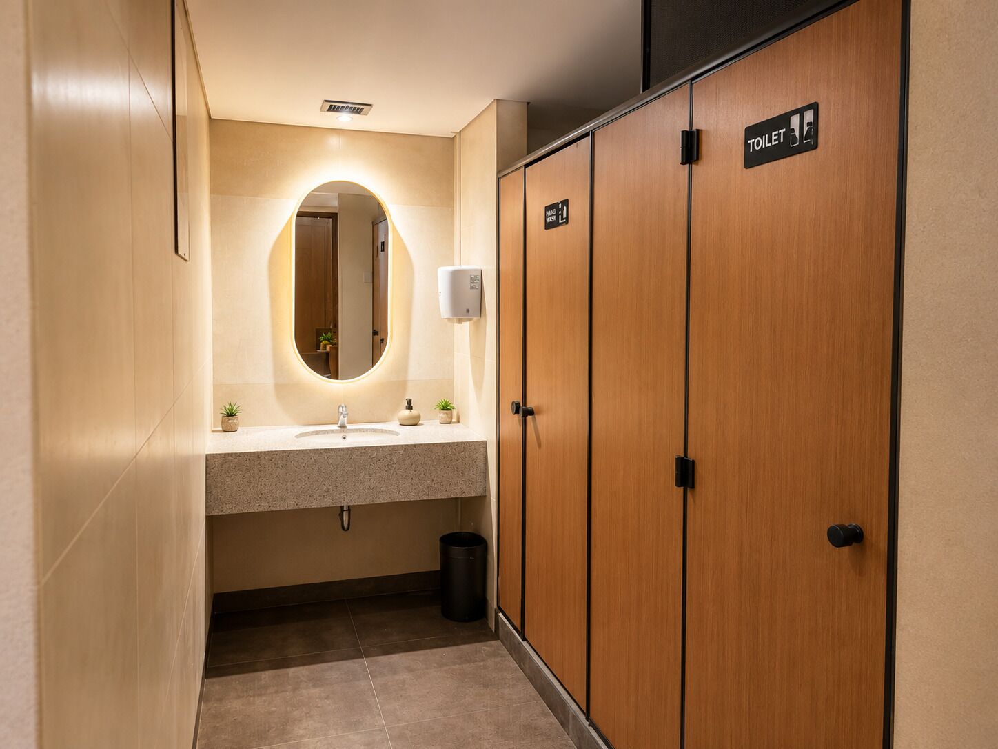 A modern bathroom with a vanity, mirror, and wooden cabinets.
